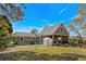 This exterior features a large backyard with green grass, a greenhouse, and a covered patio area at 710 Yucca Ave., Myrtle Beach, SC 29577