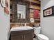 Modern bathroom with wood-paneled accent wall, a rustic mirror, and a sleek vanity at 710 Yucca Ave., Myrtle Beach, SC 29577