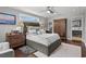 Comfortable primary bedroom featuring a ceiling fan, wood flooring, and an ensuite bathroom at 710 Yucca Ave., Myrtle Beach, SC 29577