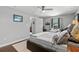 Cozy bedroom with a ceiling fan, wood flooring, and an open doorway leading to another room at 710 Yucca Ave., Myrtle Beach, SC 29577