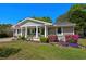 Charming single-story home with a well-manicured lawn and colorful blooming bushes at 710 Yucca Ave., Myrtle Beach, SC 29577
