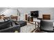 Cozy living room with hardwood floors, a black leather ottoman, and built-in shelving at 710 Yucca Ave., Myrtle Beach, SC 29577