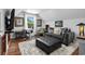 Comfortable living room featuring a plush gray sofa, ottoman, desk, and natural light at 710 Yucca Ave., Myrtle Beach, SC 29577