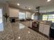 A modern kitchen featuring granite countertops, stainless steel appliances, and white cabinets at 7370 Johnson Shortcut Rd., Conway, SC 29527