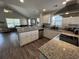 A well-equipped kitchen with granite countertops and stainless steel appliances overlooking the living room at 7370 Johnson Shortcut Rd., Conway, SC 29527