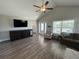 A cozy living room featuring vaulted ceilings, hardwood floors, and lots of natural light from the windows at 7370 Johnson Shortcut Rd., Conway, SC 29527
