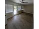 Cozy room with wood floors, multiple windows for natural light, and modern ceiling fan at 880 Briarwood Dr., Myrtle Beach, SC 29572