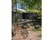 A gray house exterior with a well-maintained lawn, pathway, and lush landscaping, along with the American flag at 880 Briarwood Dr., Myrtle Beach, SC 29572