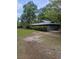 Exterior of the home featuring a large lawn and mature trees at 880 Briarwood Dr., Myrtle Beach, SC 29572
