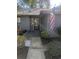 Home's entryway with glass door and the American flag, showcasing a neat garden at 880 Briarwood Dr., Myrtle Beach, SC 29572