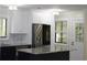 Well-lit kitchen features white cabinets, stainless steel appliances, and marble countertops at 880 Briarwood Dr., Myrtle Beach, SC 29572