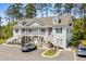 Charming two-story condo with white siding, black shutters, and well-manicured landscaping at 948 Jackline Place # 201, Murrells Inlet, SC 29576