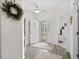 Charming foyer with decorative wreath, neutral paint, hard wood floors, and screened front door at 948 Jackline Place # 201, Murrells Inlet, SC 29576