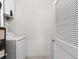 Laundry area with a white washer and dryer, a white folding door, and a white hot water heater at 948 Jackline Place # 201, Murrells Inlet, SC 29576
