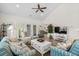 Bright living room with vaulted ceilings, ceiling fan, and access to outdoor patio through French doors at 948 Jackline Place # 201, Murrells Inlet, SC 29576