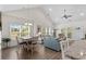 Open-concept living room with vaulted ceilings, tile floors, and lots of natural light at 948 Jackline Place # 201, Murrells Inlet, SC 29576