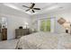 Main bedroom with ceiling fan, dresser, and a large window overlooking the yard at 948 Jackline Place # 201, Murrells Inlet, SC 29576