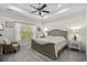 Bright main bedroom with a large window, stylish furniture, and a ceiling fan at 948 Jackline Place # 201, Murrells Inlet, SC 29576