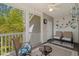 Cozy screened porch with seating, decor and wooded views at 948 Jackline Place # 201, Murrells Inlet, SC 29576