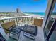 Relaxing balcony featuring two lounge chairs and a stunning view of the ocean and coastline at 9650 Shore Dr. # 810, Myrtle Beach, SC 29572
