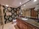 Bathroom featuring a dark wallpaper, granite countertop, and updated fixtures at 9650 Shore Dr. # 810, Myrtle Beach, SC 29572