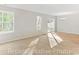 Bright living room featuring hardwood and carpet floors, windows, and sliding glass doors at 993 Cherrystone Loop, Conway, SC 29526