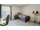 Comfortable bedroom with gray furnishings and view to the outside at 101 Cowan Pl., Myrtle Beach, SC 29588