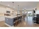 Open-concept kitchen with large island, stainless appliances, and wood flooring at 101 Cowan Pl., Myrtle Beach, SC 29588