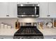 Modern kitchen featuring stainless steel appliances, a gas cooktop, and a stylish backsplash at 101 Cowan Pl., Myrtle Beach, SC 29588