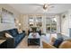 Inviting living room with hardwood floors, comfortable sofas, and bright natural light from the sliding glass door at 101 Cowan Pl., Myrtle Beach, SC 29588