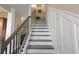 Beautiful staircase with dark wood treads, a decorative railing, and white risers at 101 Cowan Pl., Myrtle Beach, SC 29588