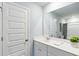 Bright bathroom with large mirror, white vanity and a decorative potted plant at 1213 American Shad Dr. # 37, Conway, SC 29526