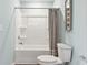Clean bathroom with a white tub/shower combo and toilet with gray curtain and modern art at 1213 American Shad Dr. # 37, Conway, SC 29526
