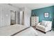 Tranquil bedroom with a teal accent wall, plush chair, and a dresser at 1213 American Shad Dr. # 37, Conway, SC 29526