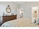 Calm bedroom with view to kitchen, dresser, and pendant mirror above the top of the dresser at 1213 American Shad Dr. # 37, Conway, SC 29526
