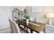 Inviting dining area with rustic table, shelving with potted plants and decorative accents at 1213 American Shad Dr. # 37, Conway, SC 29526