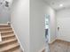 Bright entryway featuring stairs, a decorative octopus wall hanging, and a view into the dining area at 1213 American Shad Dr. # 37, Conway, SC 29526