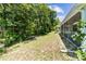 A well-maintained backyard showcases lush trees and greenery along the side of the home and screened porch at 1516 Saint George Ln., Myrtle Beach, SC 29588