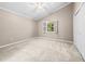 Bedroom features neutral walls, carpet, ceiling fan, and large window with open shutters at 1516 Saint George Ln., Myrtle Beach, SC 29588