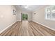 Bedroom features light hardwood floors, ceiling fan, and sliding glass door to outside at 1516 Saint George Ln., Myrtle Beach, SC 29588