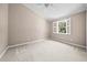 Bright bedroom features neutral walls, white trim, ceiling fan, and window with open shutters at 1516 Saint George Ln., Myrtle Beach, SC 29588