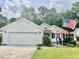 Charming single-story home with a well-manicured lawn and an inviting front patio area with seating at 1516 Saint George Ln., Myrtle Beach, SC 29588