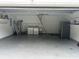 Well-lit garage space with storage shelving, laundry area, and extra refrigerator at 1516 Saint George Ln., Myrtle Beach, SC 29588