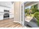 Stainless steel appliances and white cabinets in kitchen with hardwood floors and patio view at 1516 Saint George Ln., Myrtle Beach, SC 29588