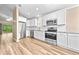 Bright kitchen features stainless steel appliances, white cabinets, modern countertops and tiled backsplash at 1516 Saint George Ln., Myrtle Beach, SC 29588