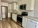 Modern kitchen features stainless steel appliances, granite countertops, and white cabinets at 1516 Saint George Ln., Myrtle Beach, SC 29588