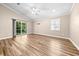 Light-filled living room with wood floors, sliding glass door and windows at 1516 Saint George Ln., Myrtle Beach, SC 29588