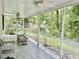 The home offers a screened-in porch with tile floors and outdoor furniture, overlooking the backyard at 1516 Saint George Ln., Myrtle Beach, SC 29588