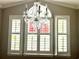 Decorative chandelier hanging in front of a large window with white shutters at 1516 Saint George Ln., Myrtle Beach, SC 29588