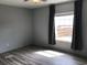Well-lit bedroom features a ceiling fan, window, and wood-look flooring, providing a cozy atmosphere at 212 Weyburn St., Myrtle Beach, SC 29579